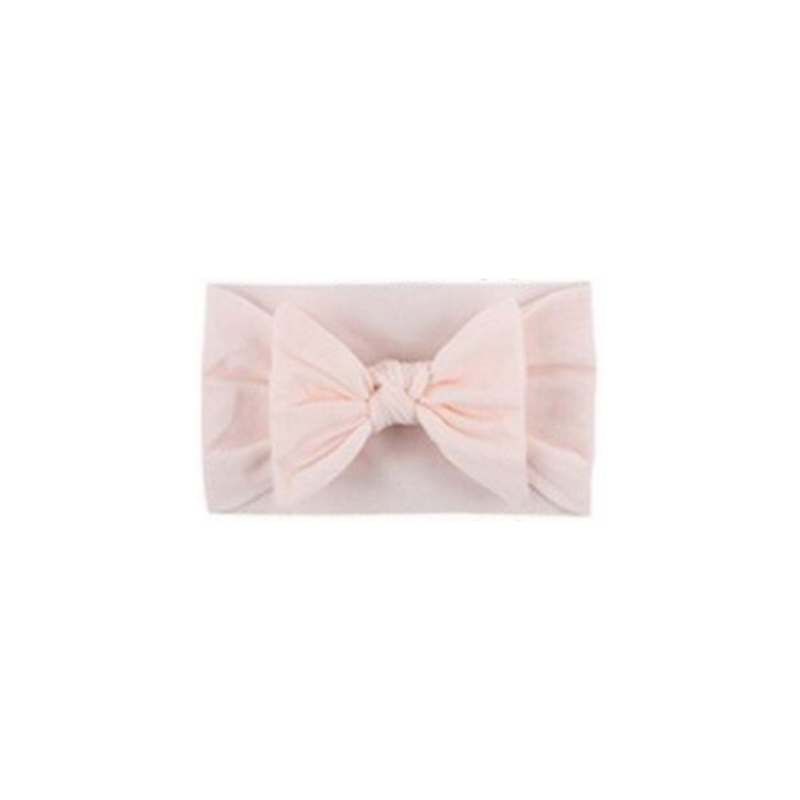 Soft fit headband with bow in light pink.