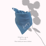 Baby cotton bib with button closure in blue.