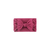 Soft fit headband with bow in blush pink.