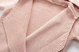 Close up of the knitted baby wrap in light pink.