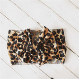 Baby headband with bow in leopard print.