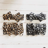 Baby headbands with bow in leopard and snow leopard prints.