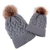 Mommy and baby knitted pom pom hat in gray.