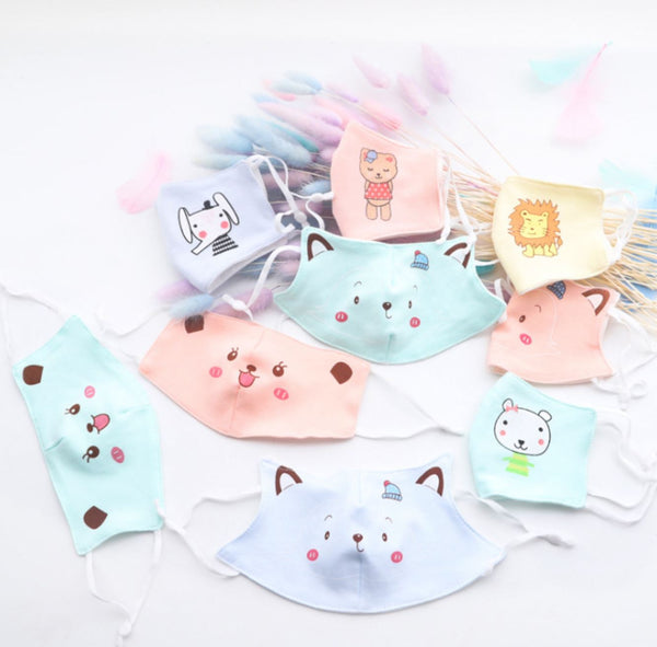 Various light blue, light pink, turquoise and yellow reusable kids' masks with cute animal faces printed on.
