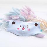 One light blue reusable kids' face mask with a happy bear face printed on the front.
