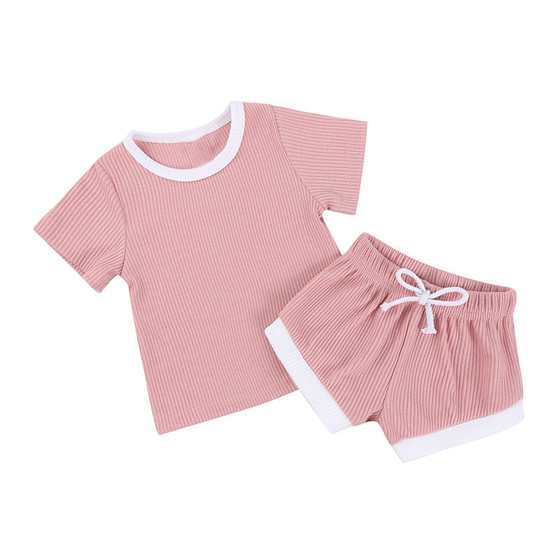 2 piece cotton tee shirt and shorts set in light pink with white trim.