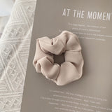 Handmade ribbed scrunchie in cream.