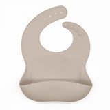 Reusable silicone bib in cream.