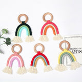 Handmade rainbow macrame wooden teether in various colours.