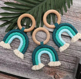 Handmade rainbow macrame wooden teether in blue.