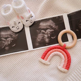 Handmade rainbow macrame wooden teether in red.