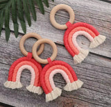 Handmade rainbow macrame wooden teether in red.