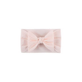 Soft fit headband with bow in light pink.