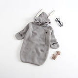 Gray knitted baby wrap with bunny ears hood.