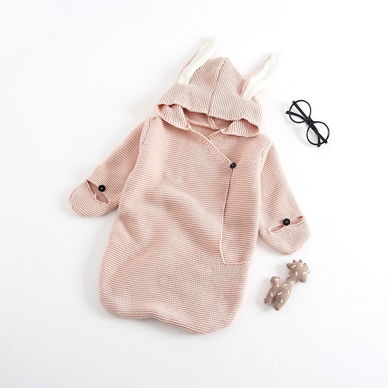 Light pink knitted baby wrap with bunny ears hood.