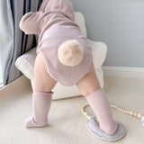 Baby wearing 3 piece matching set in mauve.  Set includes hat with bunny ears, long sleeve onesie and socks.