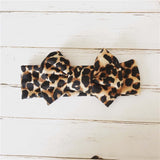 Baby headband with bow in leopard print.