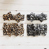 Baby headbands with bow in leopard and snow leopard prints.