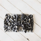 Baby headband with bow in snow leopard print.