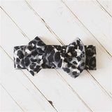 Baby headband with bow in snow leopard print.