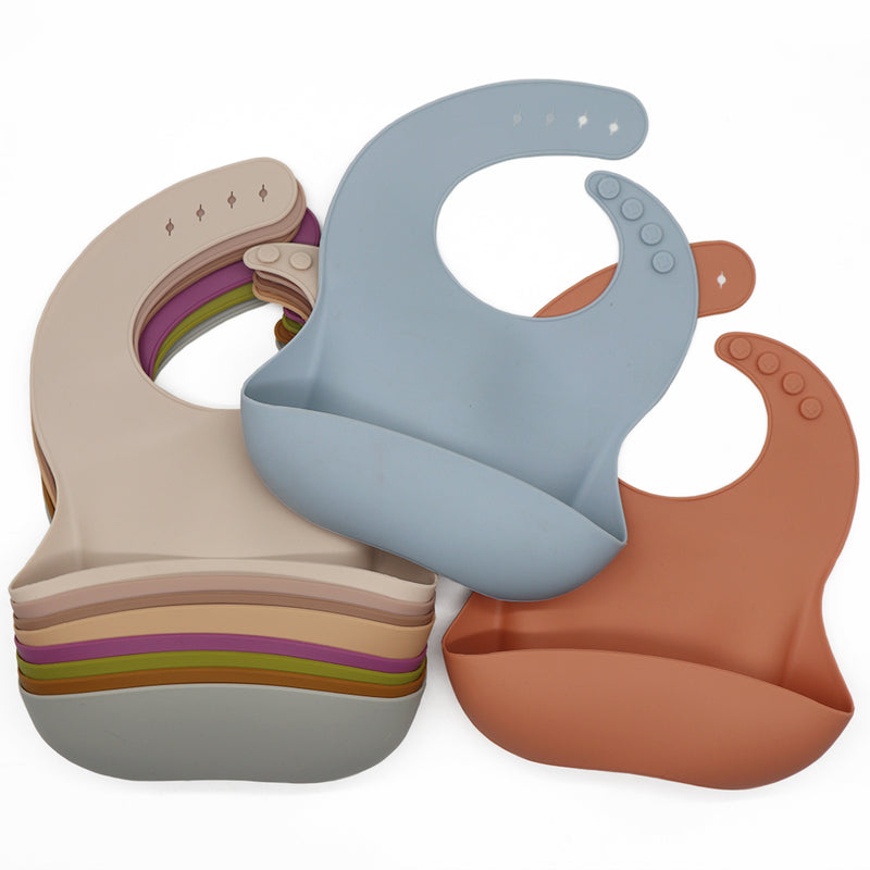 Reusable silicone bibs in various colours.
