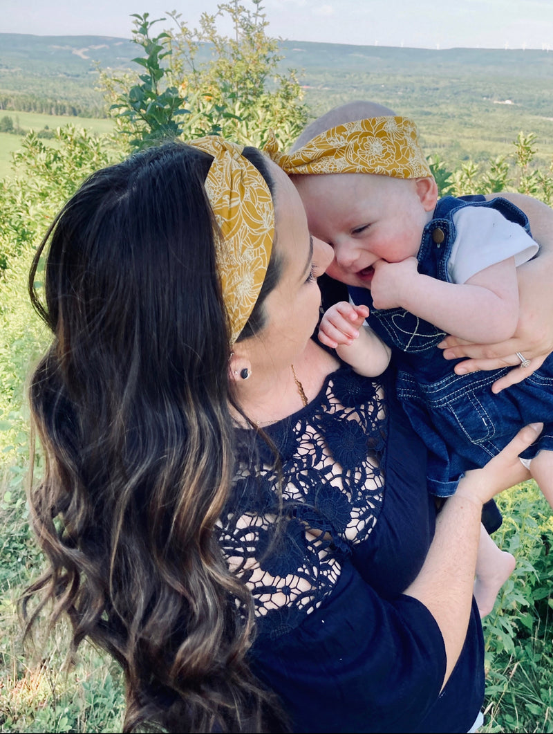 Mommy and baby wearing matching headband set in yellow floral print.