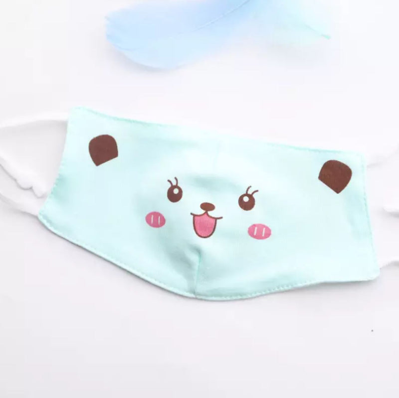 One mint coloured reusable kids' face mask with a cute smiling bear face printed on.