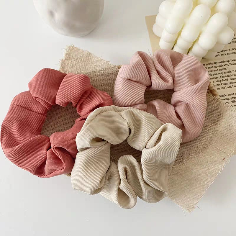 Handmade ribbed scrunchies in blush pink, light pink and cream.