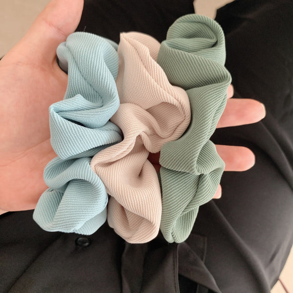 Handmade ribbed scrunchies in light blue, cream and sage.