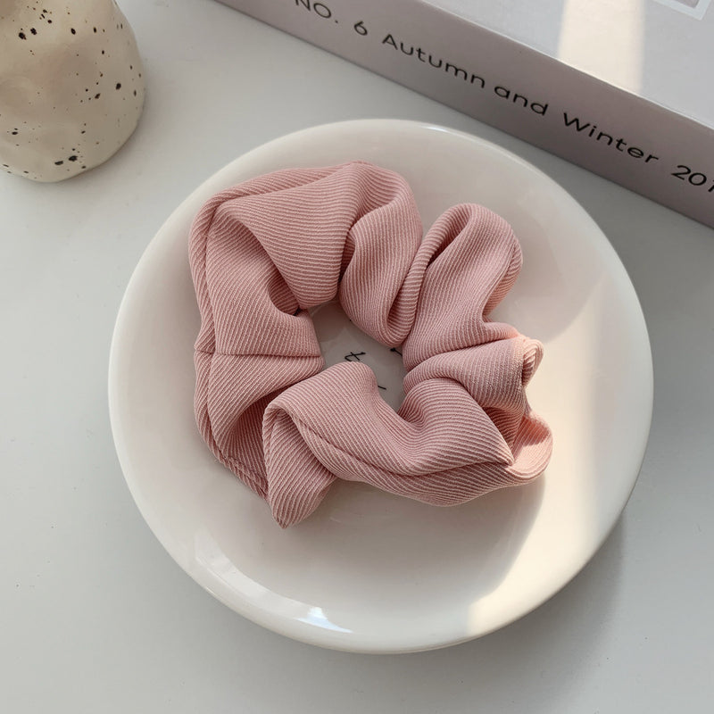 Handmade ribbed scrunchie in light pink.