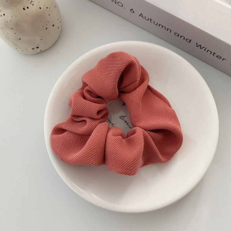 Handmade ribbed scrunchie in blush pink.