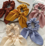Handmade bunny ears scrunchie in 5 colours, brown, mustard, pink, blue and cream.